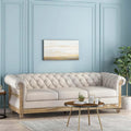 Divano a 3 posti Chesterfield beige capitonné con gambe in legno