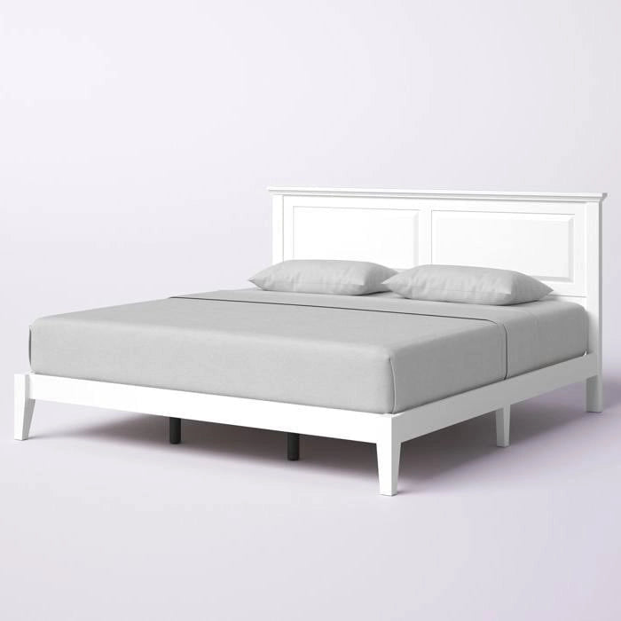 Letto a piattaforma in rovere massello con gambe affusolate e testiera