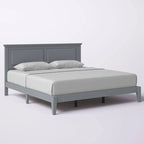 Letto a piattaforma in rovere massello con gambe affusolate e testiera