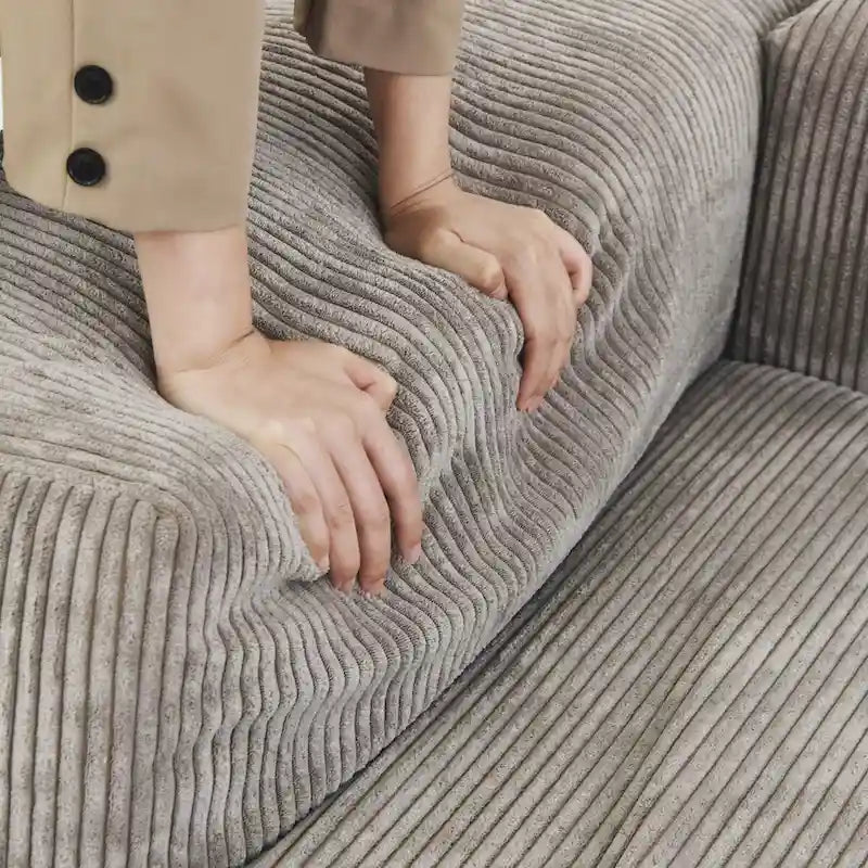 Divano sezionale in velluto a coste oversize con pouf, divano a L convertibile con seduta profonda per soggiorno moderno